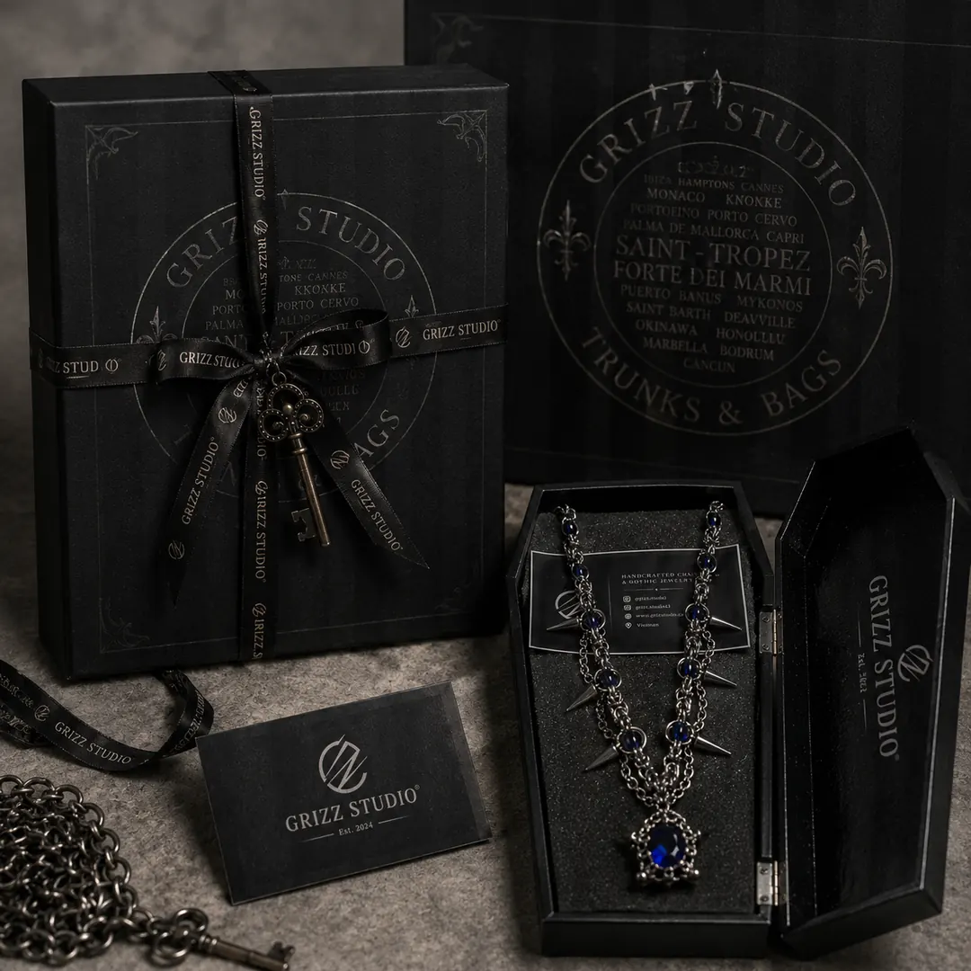 Grizz Studio® ribbon-wrapped black gift box, key charm, thank-you card and an engraved coffin box displaying a necklace