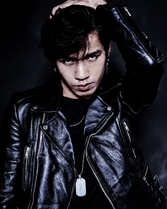 Van Duc Bui, co-founder and lead designer of Grizz Studio®, in a black leather jacket